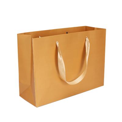 China Luxury Handmade Gold Paper Card Paper Bags Packaging Paper Gift Bag With Handle for sale