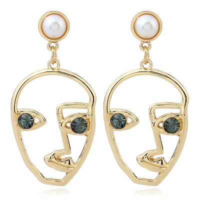 China Religious creative fashion exaggerated pearl abstract face-shaped earrings net rhinestone earrings celebrity street shot jewelry for girls for sale