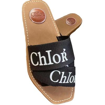 China Damping New Outdoor Beach Polygon Slippers Women Letter Ribbon Slides Flat Large Size Ladies Slippers for sale