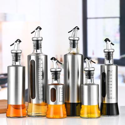 China Viable Kitchen Use Oil Containers Glass Dressing Dispenser Bottle With Pourer Mist Lid for sale