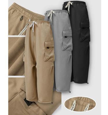 China Khaki Green Cargo Pants Mens Anti-wrinkle Series Functional Multi-pocket Leg-tucked Cargo Pants 2022 New Autumn Drawstring Pants For Men for sale