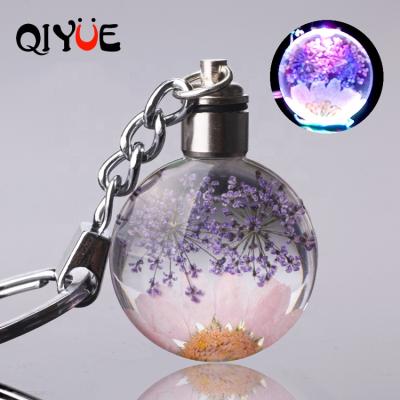 China Lead Crystal Key Chain Dry Flower Led Key Chain Light Snowdrop Flower Round Crystal Glass Pendant Keychain for sale