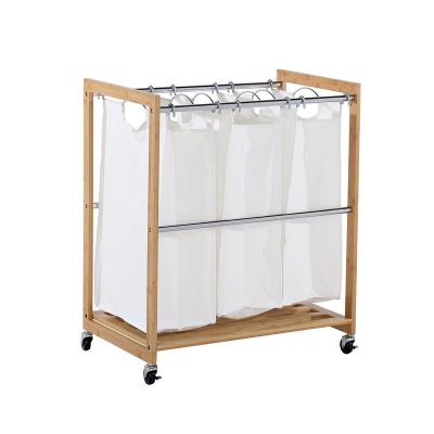 China Traditional Bamboo Laundry Hamper With 3 Expandable Laundry Bags Hamper Basket 3 Bag Laundry Sorter for sale