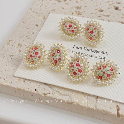 China Korea Red Beige Red Oval Floral Imitation Pearl Metal Stud Earrings Classic Irregular Geometric Reflective Vintage Oval Floral Earrings for sale