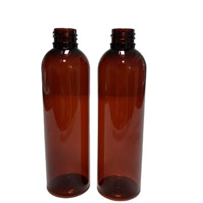 China Hot Selling 4oz Amber Pet Cosmo Rounds Plastic Lotions Bottles With Oil Dispensing Cap for sale