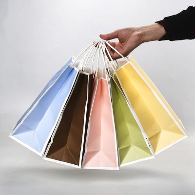 China Recycled Materials Custom Restaurant Printed Logo Gift Wrapping Paper Packaging Bag With Flat Handle for sale