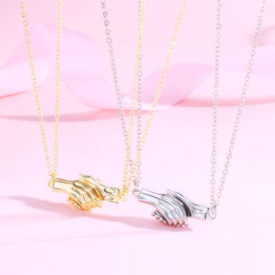 China FASHIONABLE Newcomer Unique Lover Jewelry Shaking Hands Pendant Pairs Couples Best Friend Magnetic Necklaces for sale