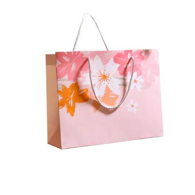 China Recyclable Free Custom Logo Design Wholesale Gift Paper Bags Paper Bags With Handle for sale