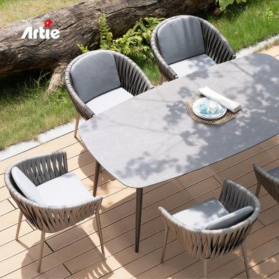 China Artie Modern PE Rattan All Weather Patio Furniture Set All Weather Aluminum Outdoor Dining Table And Chairs for sale