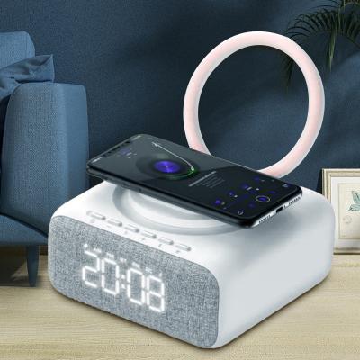 China Mini ABS Portable Alarm Clock Speaker Therapy Lamp Blue Tooth Wireless Charging Fm Night Light Stand Holder for sale