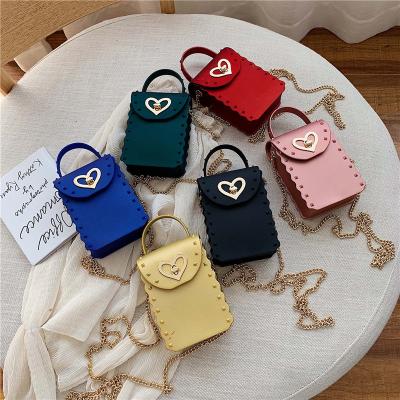 China Lady Wholesale Rivet Kids Handbags Lady Mini Heart Shaped Cell Phone Handbags Fashionable Color PVC Jelly Bag PVC Candy Bag for sale