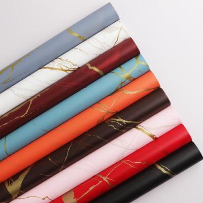 China Moisture Proof Marble Waterproof Flower Gold Paper Flower Packaging Wrapping Paper Waterproof Wrapping Paper for sale