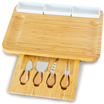 China Hot Sale Creative Rotating Stocked Knife Fruit Tray Cutting Board Set Cheese Bamboo Board for sale