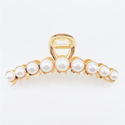 China 2022 Hair Decoration Fancy Gold Banana Hair Claw Clip Pearl Shark Large Size Bridle For Thick Hair Women for sale