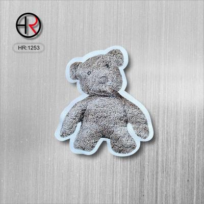 China Sustainable Fashion Garment Accessories Filled Bear Cotton Labels Factory Cheap Prices 3D Cartoon High Density UFO Woven Label For Clothing for sale