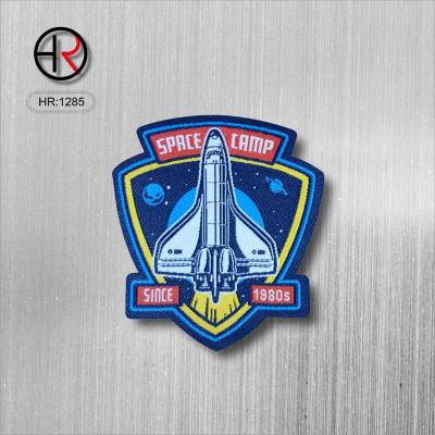 China Private custom factory price fashion clothing decoration washable spaceship label leather woven labels for garment accessories for sale