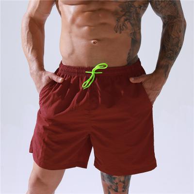 China QUICK DRY Men's Five Hundred Athleisure Shorts Big Size Waterproof Fitness Solid Color Loose Shorts Plus Size Mens Beach Pants for sale