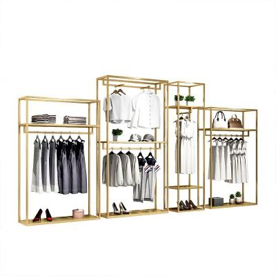 China Clothes shop shiny gold metal boutique clothing display rack luxury commercial clothing rack shelf for shops for sale