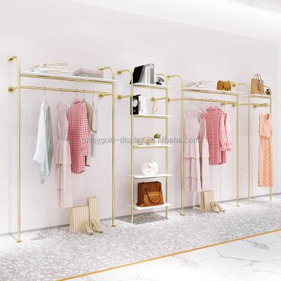 China Clothes shop luxury gold clothing rack with white marble MDF coat rack clothing store display rack for sale