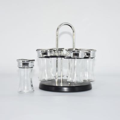 China 8pcs/set viable round shape spice glass jar set with plastic revolvin holder for sale