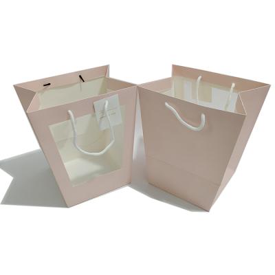 China Recyclable the latest portable pink trapezoidal window paper bag hot-selling birthday gift thickened paper bag for sale