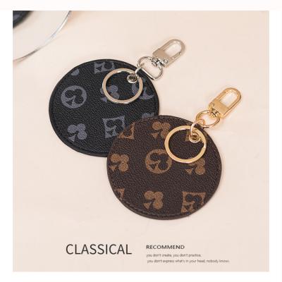 China High Quality Classic Flower Prints Key Chain Vegan Leather Handbag Decoration Round Shape Bag Charm Accessory for sale