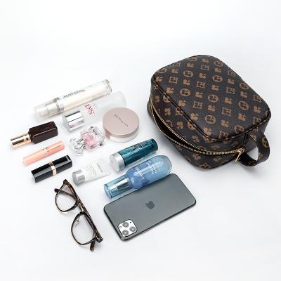 China Vegan High Quality Famous Brand Leather Clutch Purse Retro Brand Portable Travel Makeup Bag High Quality Leather Cosmetic Bag for sale