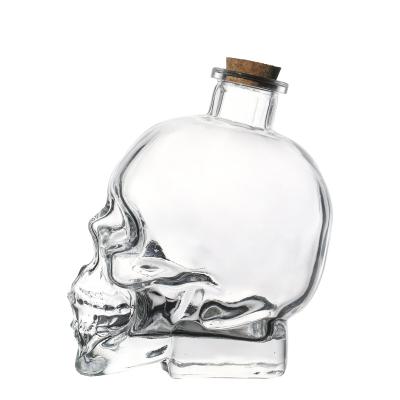 China Canned Food Customized Model Skull Shaped Flint Glass Beverage Bottles Glass Liquor Mugs 100ml 180ml 400ml 750ml for sale