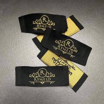 China Custom Wholesale Cheap Woven Printing Gold Sustainable Garment Label for sale