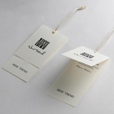 China Viable wholesale custom printed fashion swing fold garment hang tags art paper hang tags for handbags for sale