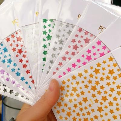 China 2022 Oosi Popular New Design Stars New Year's Shining 3D Manicure Festival Holiday Finger Decoration Design Adhesive Nail Art DIY Sticker Bulk for sale