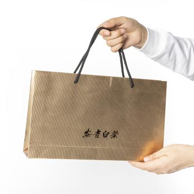 China Recyclable Gold Paper Fancy Gift Bags Shopping Gift Luxury Paper Bag PremiumPaper Bags With Company Logo for sale