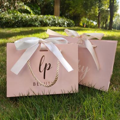 China Recycled Materials Personality Luxury Custom Printed Clothing Paper Packaging Shopping Bag for sale