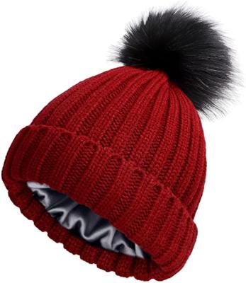 China Universal Belief Women's Cable Knit Hat Winter Satin Striped Cuffed Beanie With Detachable Faux Fur Pompom for sale