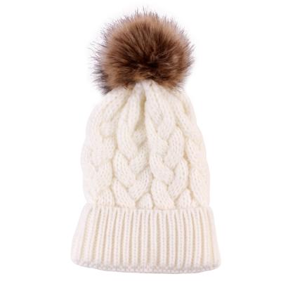 China Custom Factory COMMON Acrylic Twist Knitted Winter Hat Fur Tied Faux Beanie Hat Women for sale