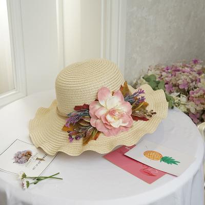 China New stylish striped ladies' beach straw hats with large wavy brims shading the sun for sale