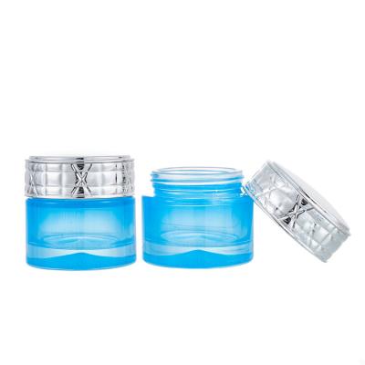 China 2021 New Personal Care Skin Care Blue Cosmetic Glass Jars 50ML With Silver Metallic Lid for sale