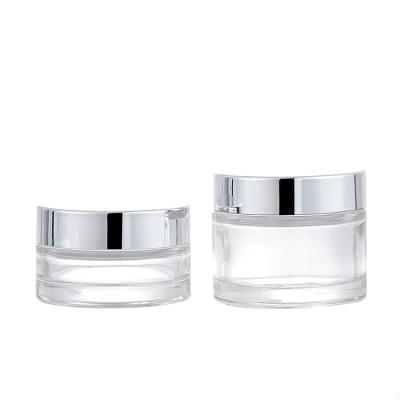 China Personal Care Round 30ml 50ml Custom Colored Clear Cosmetic Glass Jar With Shiny Silver Lids For Skin Care Cream for sale