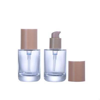 China Personal Care OEM Empty Clear Base 30ml Glass Bottle With Brown Pump for sale