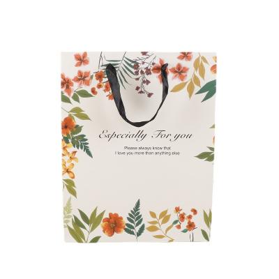 China Universal White Paper Packaging Bag Flower Tea Flower Tea Gift Clothing Paper Bag Birthday Gift Bag Packaging Box Can Print LOGO for sale