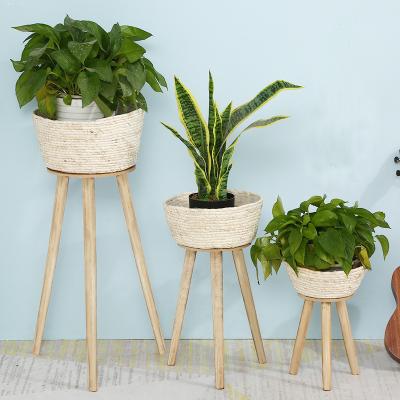 China Modern Indoor & Outdoor Office Floor Flowet Wicker Plant Basket Pot With Wooden Removable Stand Legs for sale