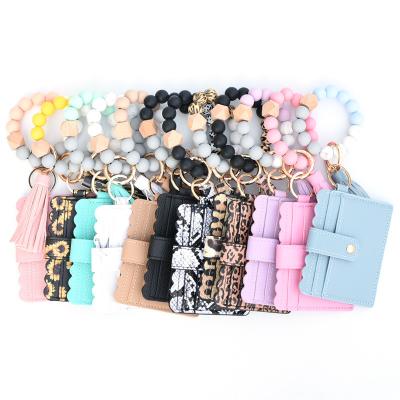 China Beaded Llavero KeychainPopular Women's Vendor Credit Cards Wallet Silicona Tassel Wristband Silicone Hot Leather Key Chain Bracelet for sale