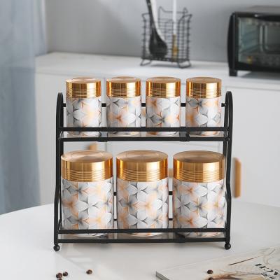 China Eco-friendly Salt Sugar Condiment Kitchen Restaurant Jars Set Cylinder Spice Container Storage Ceramic Spice Jar With Metal Holders for sale