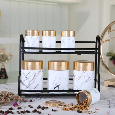 China Amber Wholesale Kitchen Viable Best Selling Goods Marble Canister Porcelain White Condiment Set Set With Metal Stand for sale