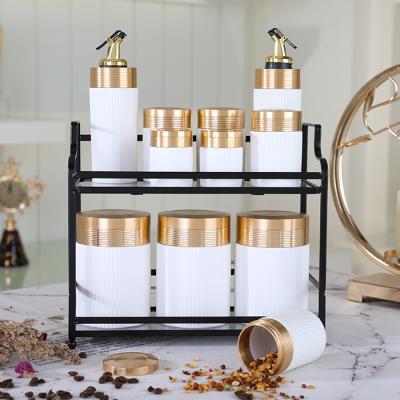 China Eco-friendly Amber Multi Function White Kitchen Used Porcelain Ware Canister Set 11pcs With AL Lid And Metal Rack for sale