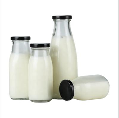 China Glass Transparent Beverage Milk And Juice Bottle With Metal Caps 250ml 500ml 1000ml for sale