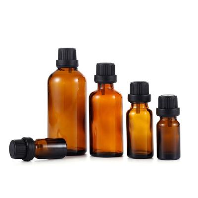 China Big Cover Perfume 5/10/15/20/30/50/100ml Round Boston Prime Anti-theft Amber Glass Essential Oil Glass Bottle for sale