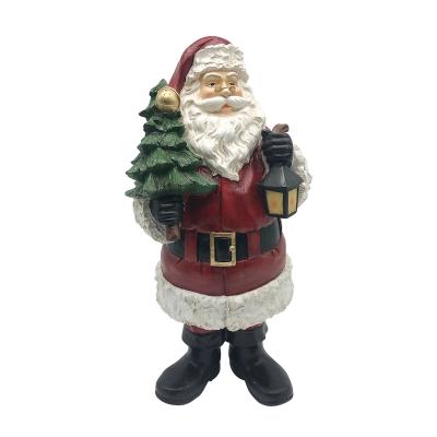 China Santa Holding Xmas Tree Statue Xmas Gifts LED Glitter Resin Christmas Decoration For Holiday for sale