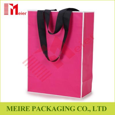 China Recycled Medium Pink color printing Paper Carrier Bags with customized LOGO and black handle for sale