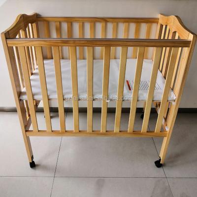 China Factory Price New Zealand Pine Folded Baby Cradle Nature For Hotel Use for sale